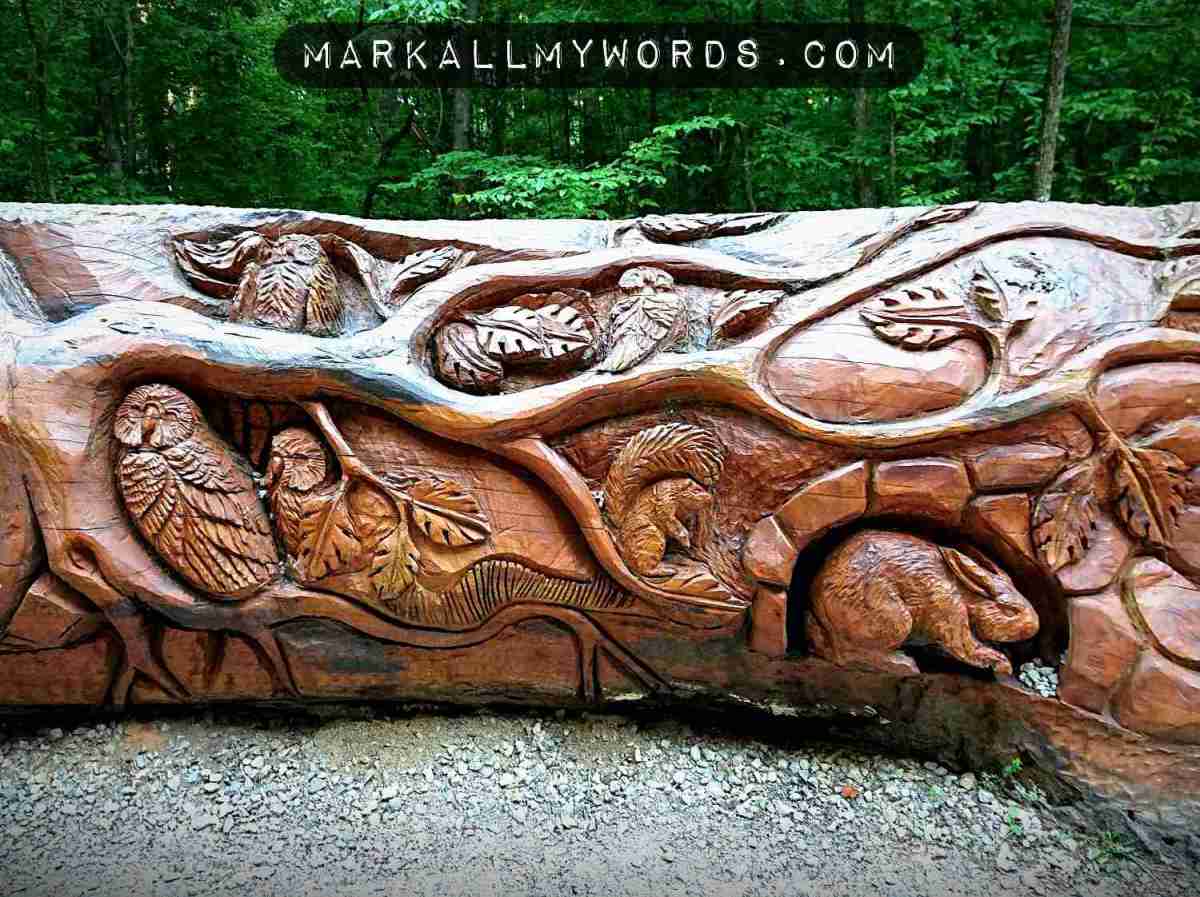 Owls, rabbits, and squirrels carved into tree sculpture
